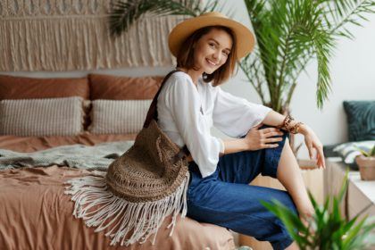 Cute woman with short hairs relaxing in her bedroom.