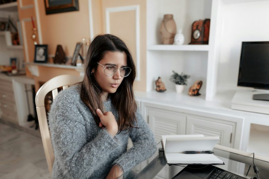 Young deaf woman having a non verbal conversation in online video call